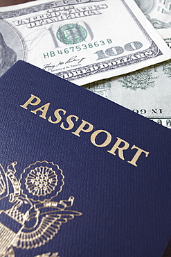 Close-up of passport and dollar banknotes