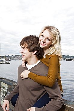 USA, Washington, Seattle, Young couple on pier, woman looking at camera