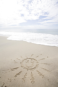 USA, Massachusetts, Sun drawn on sandy beach