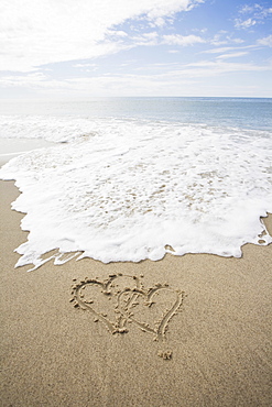 USA, Massachusetts, Hearts drawn on sandy beach