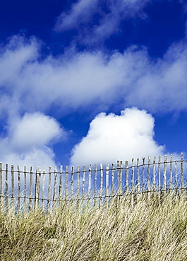 France, Picket fence, grasses and blue sky