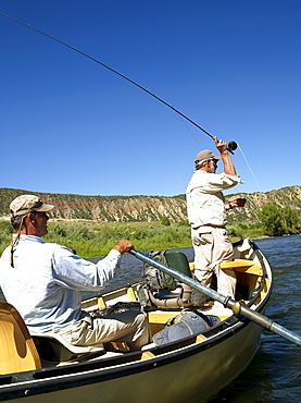 USA, Colorado, Pair of men fly-fishing on mountain river