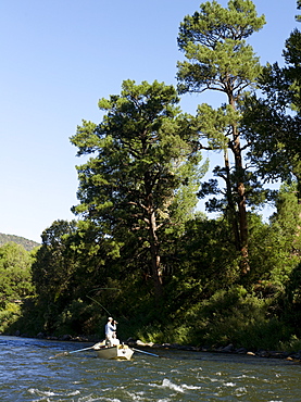 USA, Colorado, Pair of men fly-fishing on mountain river