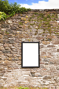 Blank sign on stone wall 