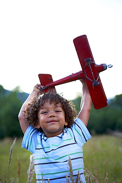 Portrait of boy (2-3) playing with toy aeroplane