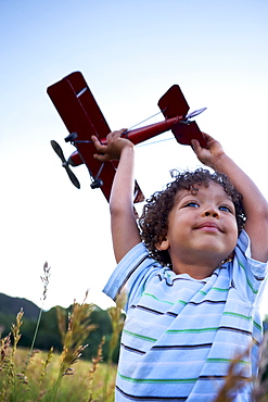 Boy (2-3) playing with toy aeroplane