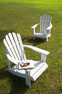 Two adirondack chairs on lawn