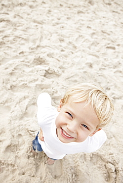 Boy (4-5) looking at camera and smiling