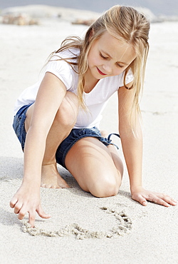 Girl (10-11) playing on beach