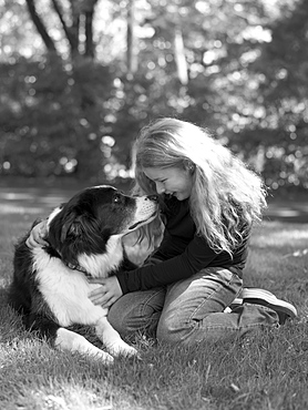 Young girl playing with dog