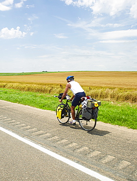 Adventure cyclist biking on rural road