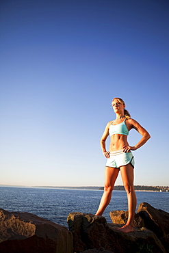 Athletic woman standing by the ocean