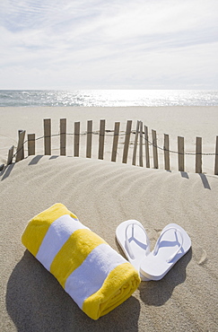 Towel and flip flops on the beach