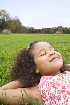 Girl lying on grass