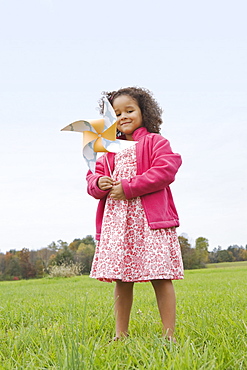 Girl playing with toy windmill