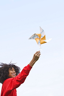 Girl playing with toy windmill