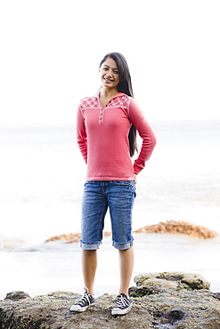 Girl standing in front of ocean