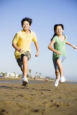 Children running on beach