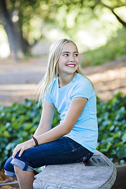 Young girl sitting on bench