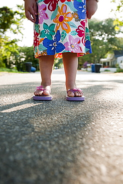 Young girl wearing flip flops