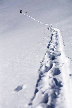 Person walking in snow up mountain, Aspen, Colorado, USA 