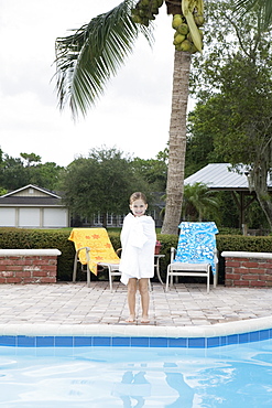 Girl standing at edge of swimming pool