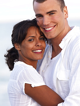 Young couple hugging on beach