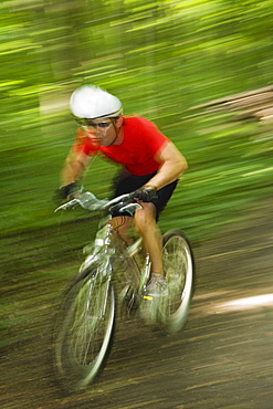 Blurred shot of man riding mountain bike