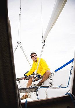 Man steering sailboat