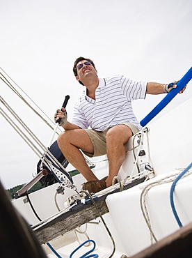 Man steering sailboat