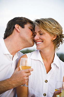 Man kissing wifeâ€™s cheek