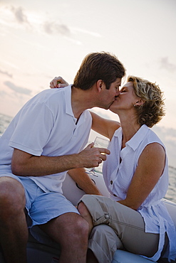 Couple kissing on boat