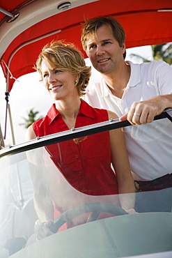 Couple driving boat