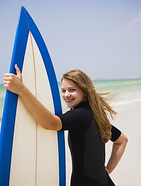 Girl holding surfboard, Florida, United States