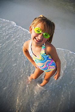 Girl wearing goggles at beach, Florida, United States