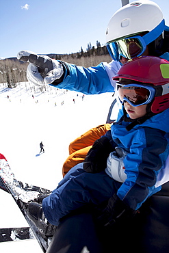 USA, Colorado, Telluride, Father with son (2-3) on ski lift