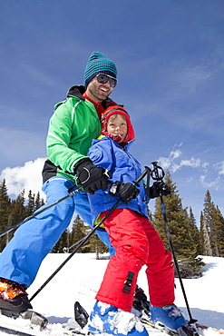 USA, Colorado, Telluride, Father with son (8-9) skiing together