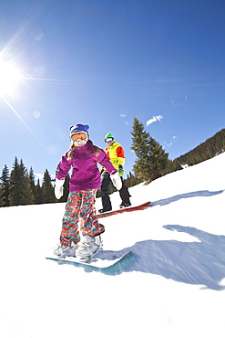 USA, Colorado, Telluride, Father and daughter (10-11) snowboarding 