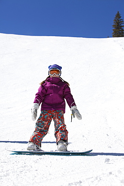 Girl (10-11) snowboarding 