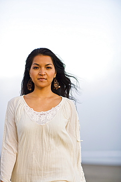 USA, California, Stinson Beach, Portrait of young woman on beach