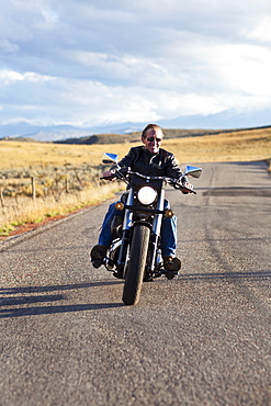 USA, Colorado, Carbondale, Mature man driving motorcycle
