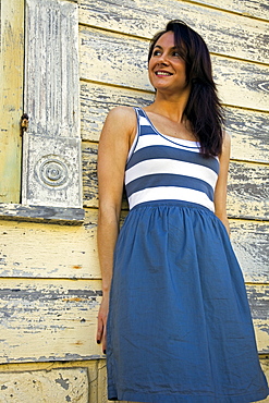 USA, Louisiana, New Orleans, portrait of woman leaning against wooden wall