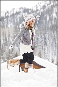 USA, Utah, Salt Lake City, young woman walking through snow in resort