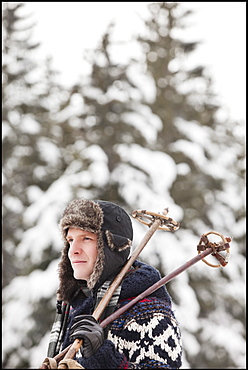 USA, Utah, Salt Lake City, man carrying ski poles