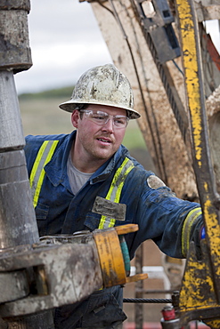 Oil worker drilling for oil on rig