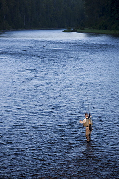 Canada, British Columbia, Fernie, Man fly fishing in river