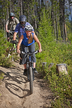 Canada, British Columbia, Fernie, Group of three people enjoying mountain biking