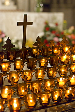 Cross with candles in cathedral