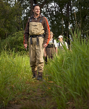 Fly Fisherman walking on path