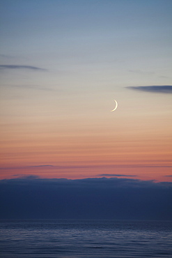 Crescent moon over the ocean, Winchester Bay, OR